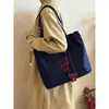 Bolsa de Lona Bordada con Letras Coreanas 2025 Nueva Bolsa de Hombro Tipo Tote con Cierre de Cordón Bolso de Nicho para Viajes Diarios