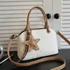 Bolso nuevo para mujer 2026 transfronterizo, bolso de mano simple y texturizado para el trabajo, bolso de hombro y cruzado de nicho vintage de alta gama