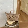 Bolsa feminina de camurça 2026 novo outono vintage Maillard bolsa de mão para o trabalho bolsa de ombro transversal poá