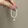 Mini Labubu Cuarta Generación Caja Sorpresa Ropa de Muñeca Collar Colgante Labubu 26 Letras Collar de Perlas Accesorios de Joyería