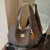 Bolsa de tela de gran capacidad para mujer otoño e invierno 2026 nueva bolsa de lona versátil bandolera estilo perezoso bolsa de mano para ir al trabajo