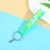 Venta Directa de Fábrica Cuerda de Cuero de Goma Suave de PVC Llavero Accesorios Lindos de Letras Felices Correa Accesorios para Bolsas Muñecas