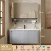 Tocador de baño engrosado y ahorrador de espacio con diseño en color crema, que cuenta con un lavabo redondeado, lavabo cerámico integrado y un lavabo de una sola pieza.