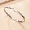 Pulsera popular de acero inoxidable con hebilla en forma de O finamente grabada pulsera de pareja moderna versátil venta al por mayor