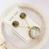 Nuevo especial transfronterizo explosión de tendencia europea y americana titanio acero alta calidad color collar pendientes traje femenino joyería de concha real