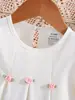 Ropa para niños de comercio exterior, primavera y otoño, vestido para bebé con cuello redondo, color liso, flores pequeñas dulces tridimensionales y puños con volantes