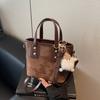 Bolso de Hombro Tipo Cubo de Textil Único de Moda para Mujer Otoño e Invierno Nuevo Bolso Cruzado Trendy Versátil Estilo Occidental Portátil para Mujer