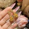 Pendientes de gota de agua exquisitos de lujo ligeros con incrustaciones explosivas de circonita transfronteriza Camellia que muestran temperamento, joyería de moda que combina con todo.