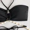 Traje de baño de dos piezas para mujer para comercio exterior transfronterizo, color liso con cuello halter y tirantes cruzados, cadena de conchas, diseño hueco y bikini de atar