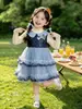 Conjunto de Vestido Bolo com Gola de Boneca Cartoon Outono para Meninas 2026 Novo Conjunto de Duas Peças Vestido Princesa Infantil Roupa Infantil Atacado
