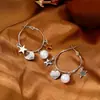 Brincos de Metal Prateado em Formato de Estrela e Coração Estilo Casual e Descolado para Mulheres 2025 Novos Brincos de Design de Nicho