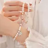 Pulsera de cordón ajustable con flor de circón y perla de estilo francés, una pieza de joyería lujosa y elegante que es tanto dulce como versátil