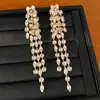 Aretes de aguja plateada con diamantes, aretes largos de borla redonda, sensación de lujo ligero y alta gama, estilo europeo y americano, aretes únicos y exagerados