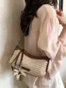 Bolso de mujer tejido a mano de paja de nicho transfronterizo, nuevo modelo de verano 2026 para el trabajo y los desplazamientos, bolso de hombro único, bolso cruzado elegante y moderno