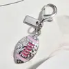 Nuevo Colgante Metálico Rosa Plateado Forma de Corazón Botella de Perfume de Cereza Llavero Accesorio Versátil para Bolsa Venta al por Mayor Dropshipping