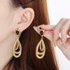 Diseño de pendientes de acero inoxidable con forma de gota de aceite negra, bucle irregular estilo Hong Kong, pendiente de viento frío de acero de titanio