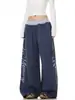 Pantalones casuales de retazos con estampado de letras desgastado estilo retro americano, unisex streetwear holgados de pierna ancha con pierna curva