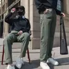 Pantalones casuales funcionales populares de otoño, nuevos para trabajo al aire libre, con etiqueta blanca pequeña, holgados y versátiles, estilo de alta costura moderno para hombres y mujeres, adecuados para parejas