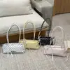Bolsa de mão doce de nicho estilo coreano para mulheres, novo modelo primavera 2026, bolsa de ombro/axila com laço única e moderna