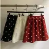 Falda Corta de Lunares de Cintura Alta Adelgazante Estilo Coreano para Navidad y Año Nuevo para Mujer Otoño Invierno Nueva Falda Corta Simple Anti-Exposición