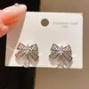 Pendientes de plata chapada en oro real de 18 quilates con aguja de plata y circonita en forma de lazo, estilo suave y dulce, pendientes de lujo ligero y de alta gama para mujer