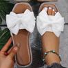 Zapatillas planas de estilo nuevo 2025 transfronterizas con lazo de pedrería para mujer para usar, sandalias de tela ligera de color puro