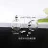 Venta al por mayor del fabricante Bola de Cristal Transparente Retorcida Abrible Bola de Cristal Colgante Hueco Botella Botella de Cinabrio Botella Vacía Botella de Tallado en Arroz