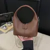 Bolsa de Dumpling Portátil de Nicho Transfronteiriça para Mulheres 2025 Nova Versátil Bolsa de Axila Simples e Estilosa Bolsa Transversal com Alça de Corrente