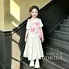 2026 Novo Estilo Fashionável Simples Personalidade Ombro a Ombro Manga Curta Camiseta Doce Laço Saia Conjunto de Duas Peças para Crianças de Meia-Idade e Mais Velhas