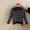 Novo look de outono para meninas: um conjunto de duas peças moderno com um cardigã listrado de malha com gola polo e zíper e calças versáteis de perna larga