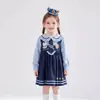 Vestido de Niña Primavera/Otoño 2026 Moda Infantil Falda de Dibujos Animados Bebé Niña Cuello de Muñeca Falso Dos Piezas Falda Estilo Universitario