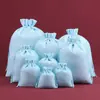 Bolsa de regalo navideña con cordón para guardar joyas, ideal para eventos transfronterizos.
