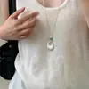 Nuevo collar colgante ovalado hueco de plata esmerilada con turquesa para mujer, joyería de nicho de lujo ligero de alta gama para mujer