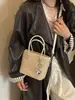 Bolso pequeño de alta gama con patrón tejido de nicho para mujer, nuevo bolso cruzado versátil de moda 2026, bolso tipo cubo de mano estilo ins