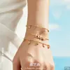Design minimalista estilo francês com cravação de zircônia, série de pingentes múltiplos, aço inoxidável banhado a ouro 18k, pulseira e colar de joias femininas