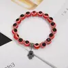 Colgante de aleación transfronteriza hueco en la palma ojos azules con cuentas pulsera elástica joyería simple para parejas ventas directas de fábrica