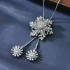 Fábrica directa otoño e invierno copo de nieve giratorio cadena suéter broche moda temperamento ropa ramillete accesorios copo de nieve collar largo