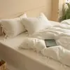 Juego de ropa de cama jacquard de algodón 100% puro, blanco puro, Clase A, elegante y sencillo, de cuatro piezas, con funda de edredón, sábana plana y sábana ajustable para dormitorio principal del hogar.