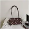 Bolso de axila de lunares estilo coreano, nicho súper popular para mujer, nuevo modelo otoño 2026, bolso de hombro exquisito y elegante, versátil para el trabajo