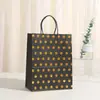 Bolsa de regalo creativa simple al por mayor punto dorado lunares bolsa de embalaje nueva fiesta cumpleaños compras portátil piel de vaca