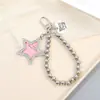 Nuevo llavero colgante de etiqueta de estrella de cinco puntas de diamante textura metálica accesorios de hueso de perro decoración de bolsa creativo