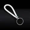 Llavero colgante de cuerda de cuero tejido de fábrica con cabeza de plástico para pareja, llavero de coche de cuero, colgante, accesorios, venta al por mayor