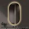 Espejo de baño inteligente ovalado en stock con lijado exterior e iluminación LED translúcida, adecuado para montaje en pared de baño y proyectos hoteleros, con opciones de personalización.