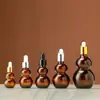 Botella gotero de punta de pegamento de calabaza doble marrón al por mayor Botella con roller para aceite esencial Botella cosmética Botella vacía reempaquetada para loción de esencia