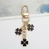 Novo Chaveiro Pingente de Flor Colorida Ins Criativo DIY Liga Gotejamento de Óleo Cabeça de Flor Unilateral Decoração de Bolsa de Fone de Ouvido