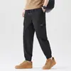 Pantalones cargo de color liso estilo americano para hombre, nueva colección de otoño, corte holgado, tobillos con puño, pantalones largos casuales multibolsillos, pantalones con puño estilo ropa de trabajo
