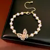 Collar de cuentas chapado en oro real de 18 quilates con mariposa de circón y perla, cadena para la clavícula de lujo ligero y exclusivo, exquisito juego de joyas