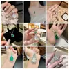 Collar para mujer con colgante bañado en plata con figura de Buda de calcedonia blanco hielo, diseños de hoja y calabaza, ágata y jade de Maitreya