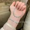 Venta al por mayor de fábrica alta calidad natural material peligroso pulsera de jade azul agua diseño pequeño fresco incrustación de plata s925 mujer