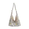 Bolsa de lona de gran capacidad para mujer, nuevo modelo 2026, estilo commuter de alta gama, estampado floral dulce, bolso tote de un solo hombro para llevar debajo del brazo